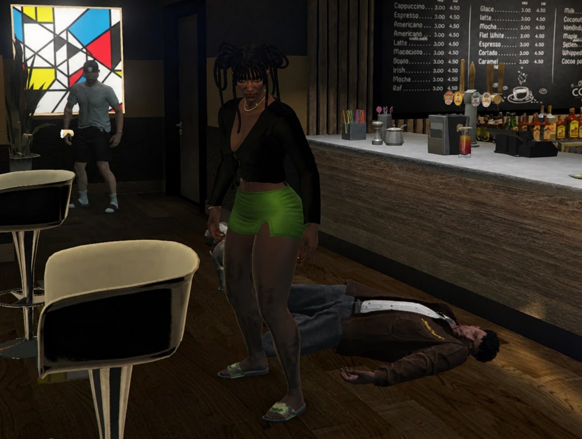 A man lying on the coffee shop floor after the second fight, as a woman stands over him