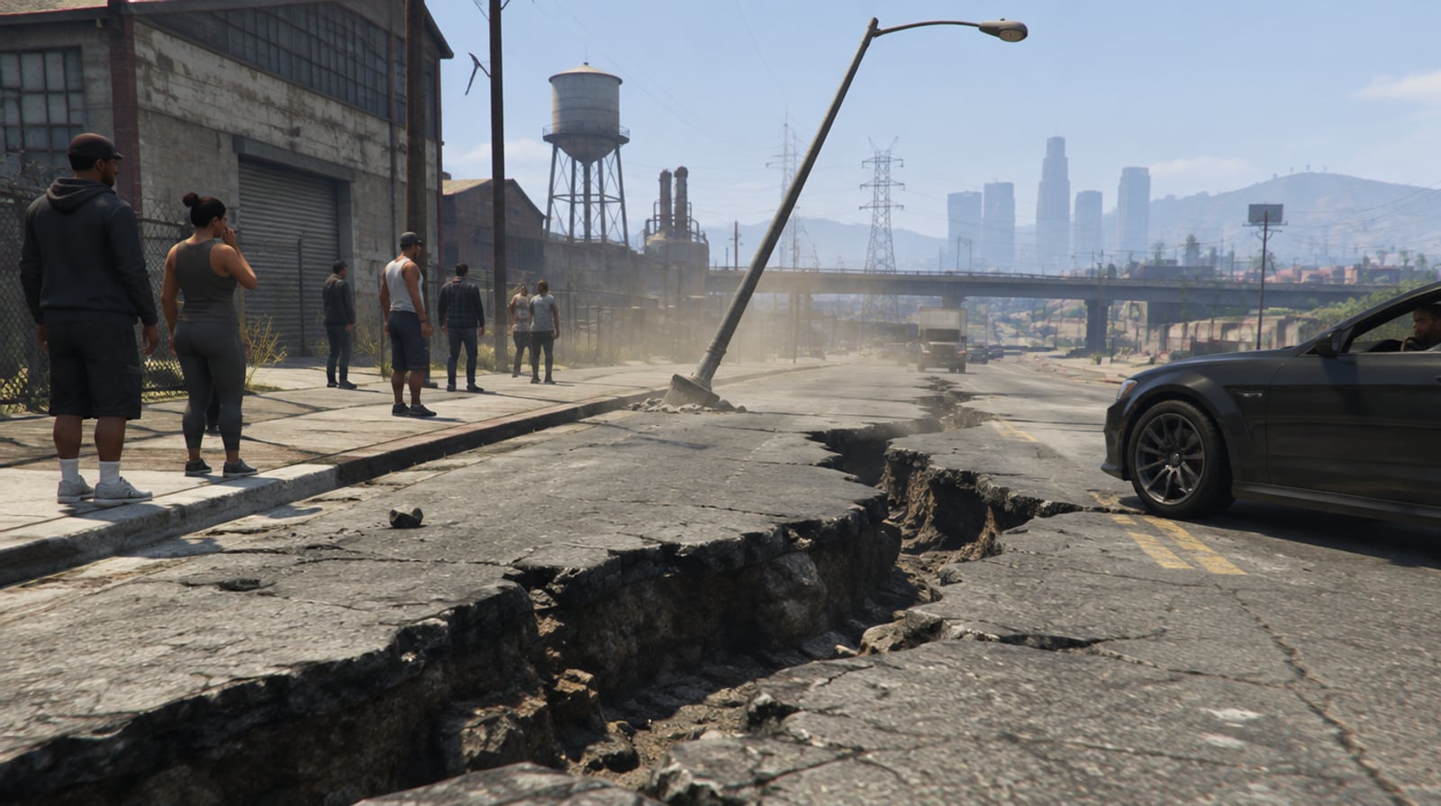 A deep crack across a road in east Los Santos with a leaning streetlight as residents look on